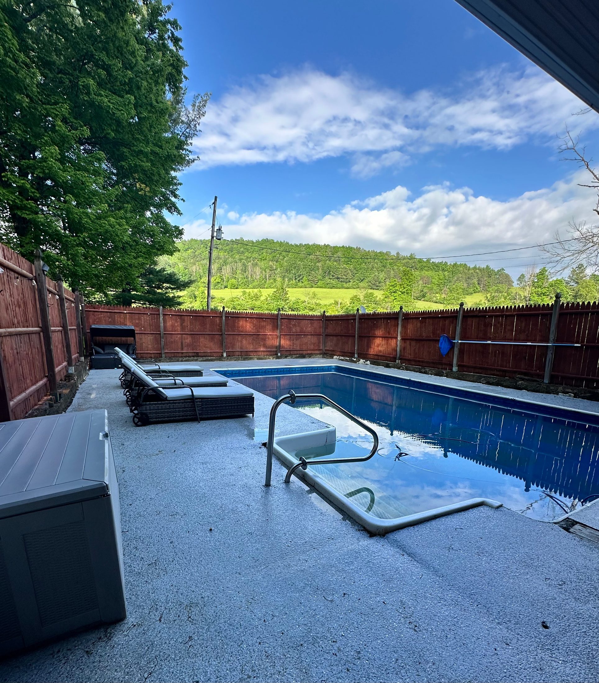 Pool at Serenity Woods Sanctuary with a green hillside view
